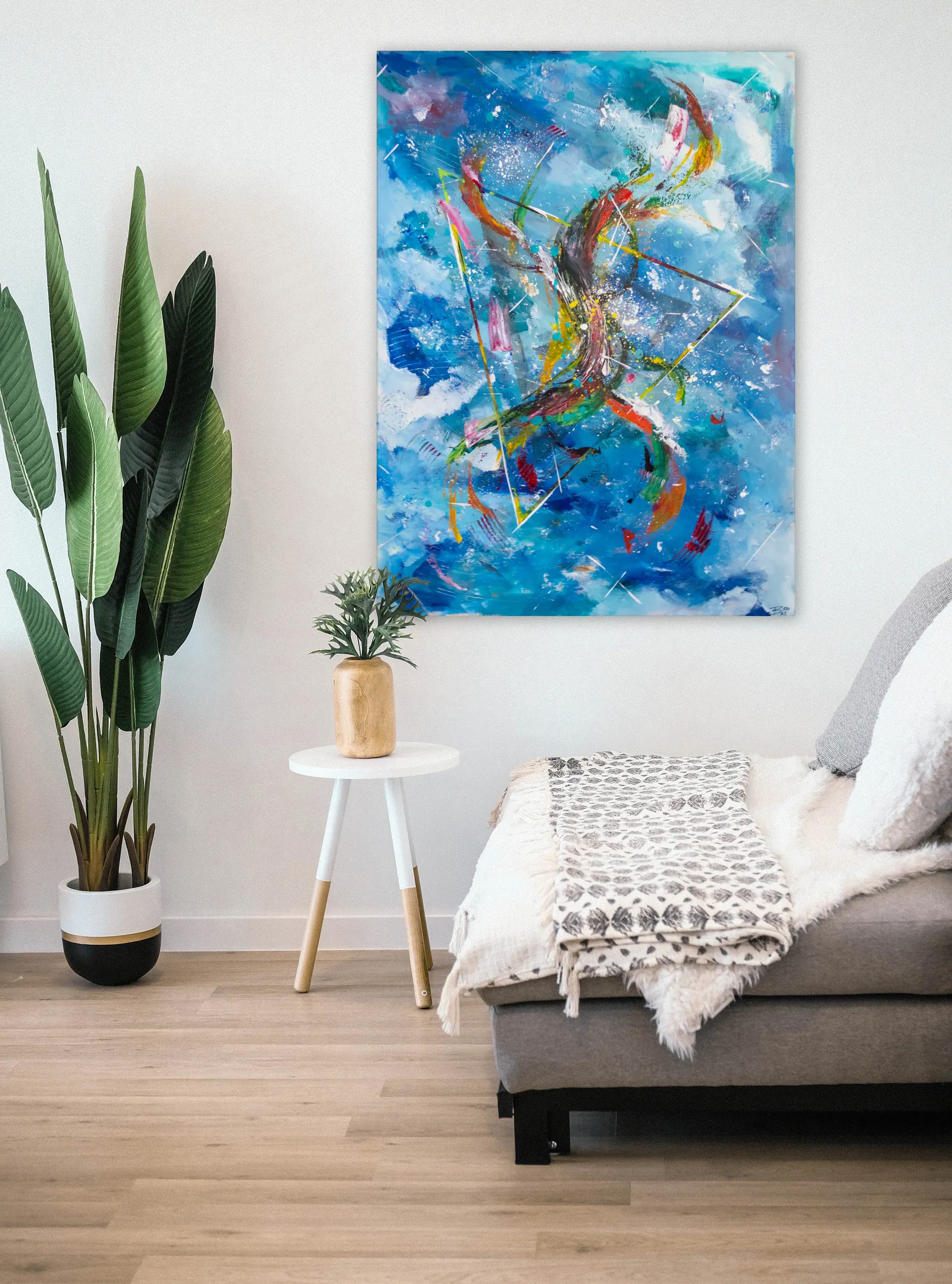 On a white wall beside a daybed and a tall potted plant